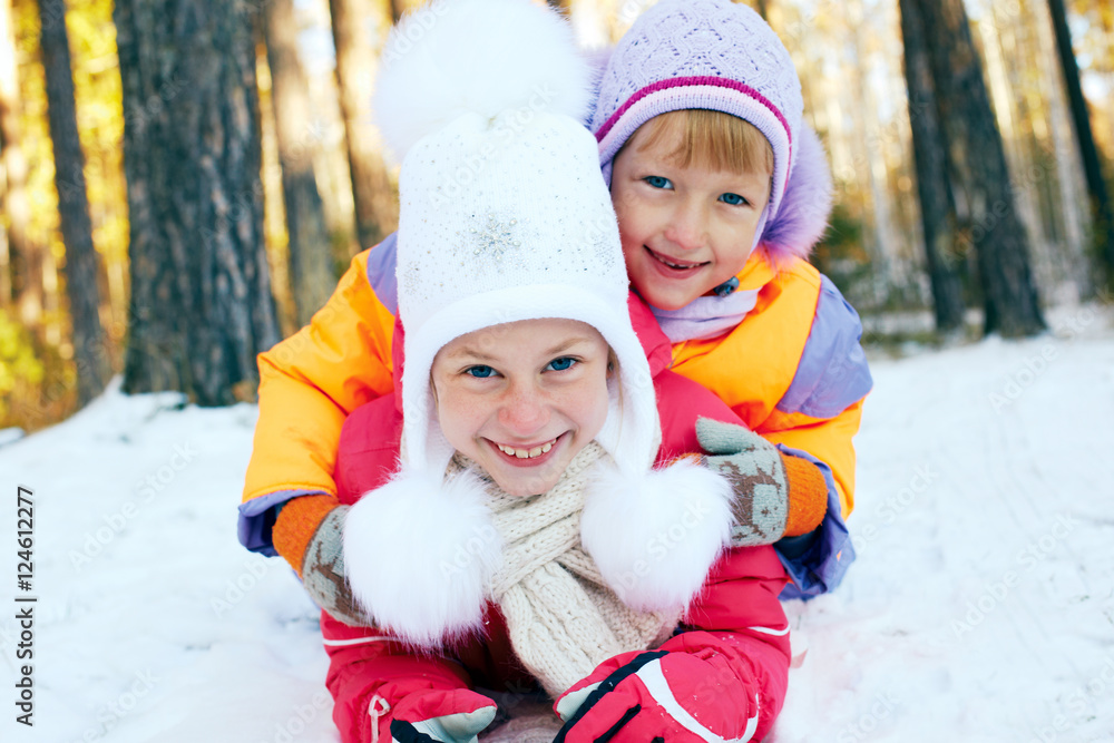 Children ride from the snow slide. Winter fun Children ride from the snow slide. Winter fun