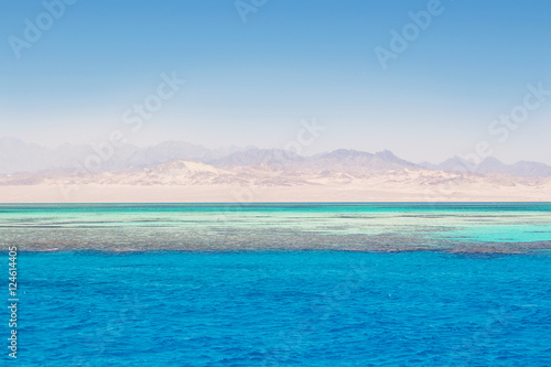 clear blue Red Sea with coral and white sand strip, Egypt