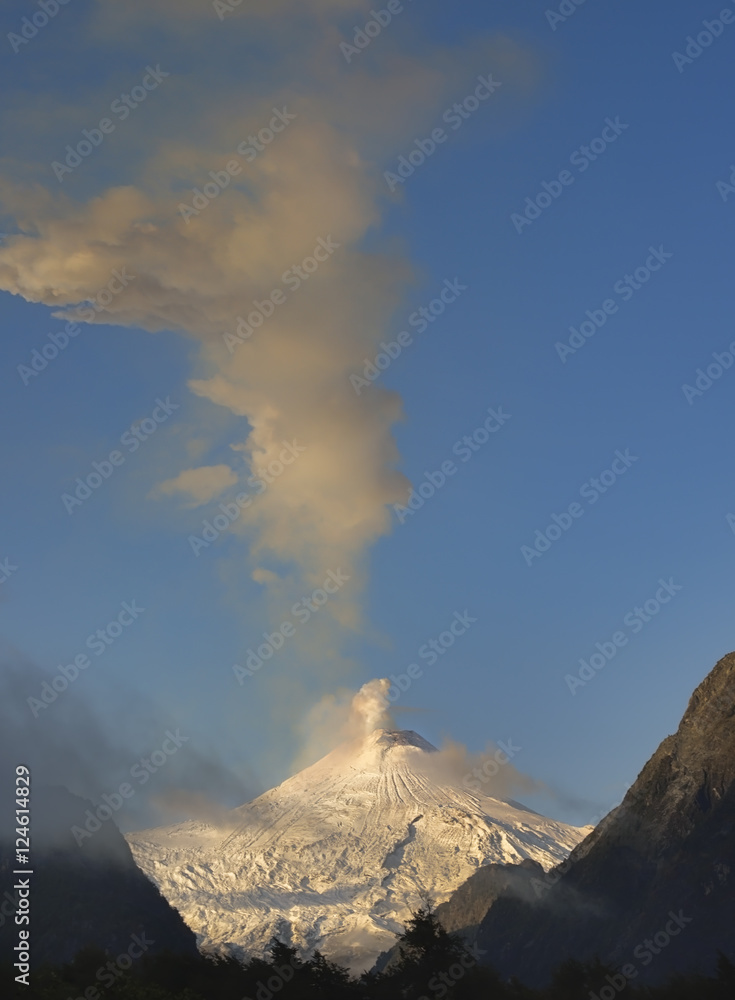 Golden light on active volcano Villarrica with snowy summit, Pucon, Chile