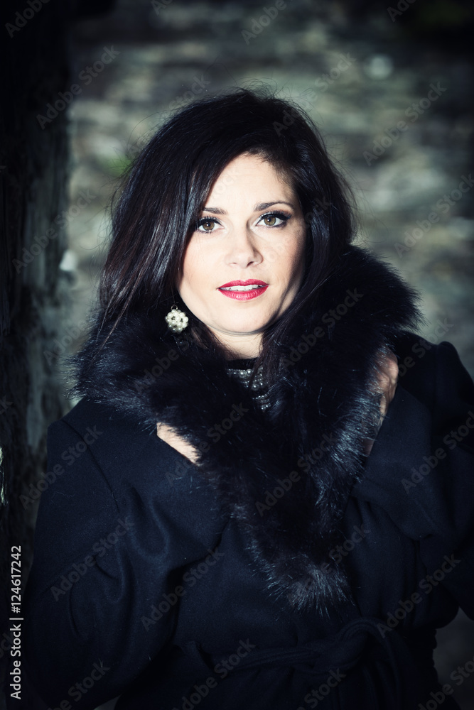 Sexy young brunette with black coat looks at camera Sexy young brunette with black coat looks at camera
