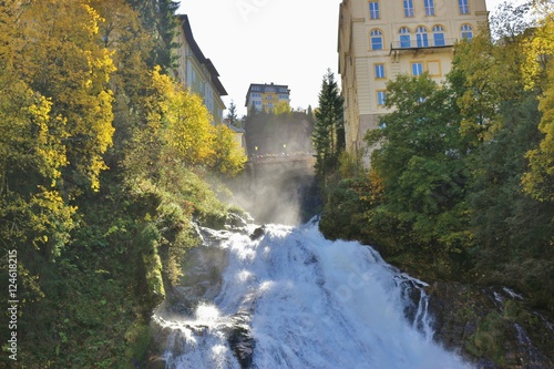 A waterfall plunging through the town Bad Gastein, a famous health resort and also ski resort. Austria, Province of Salzburg, Europe. photo