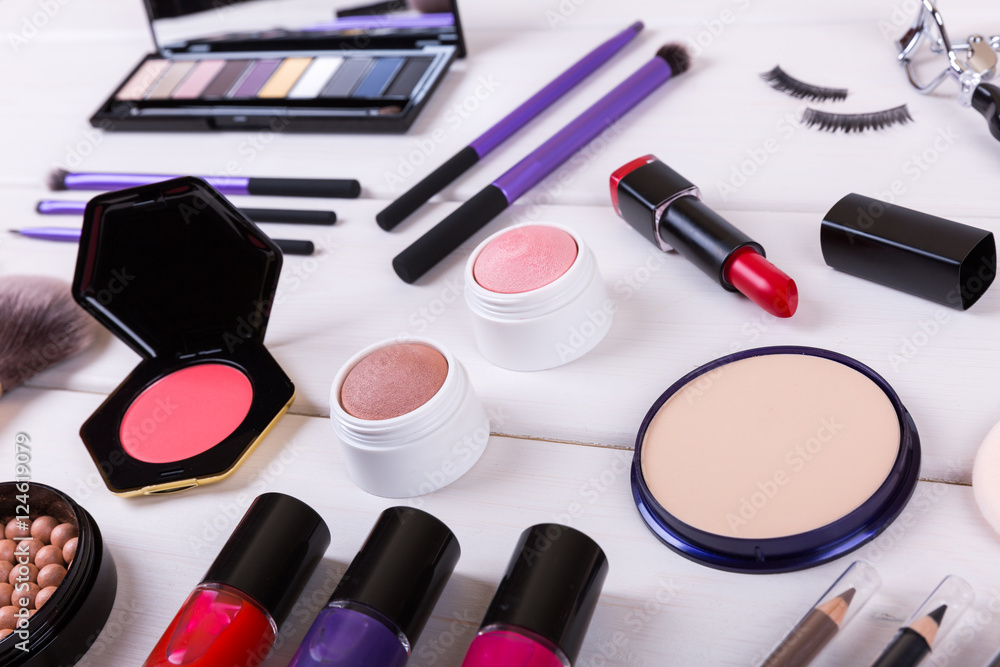 closeup of makeup cosmetics on wooden table closeup of makeup cosmetics on wooden table