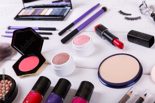closeup of makeup cosmetics on wooden table