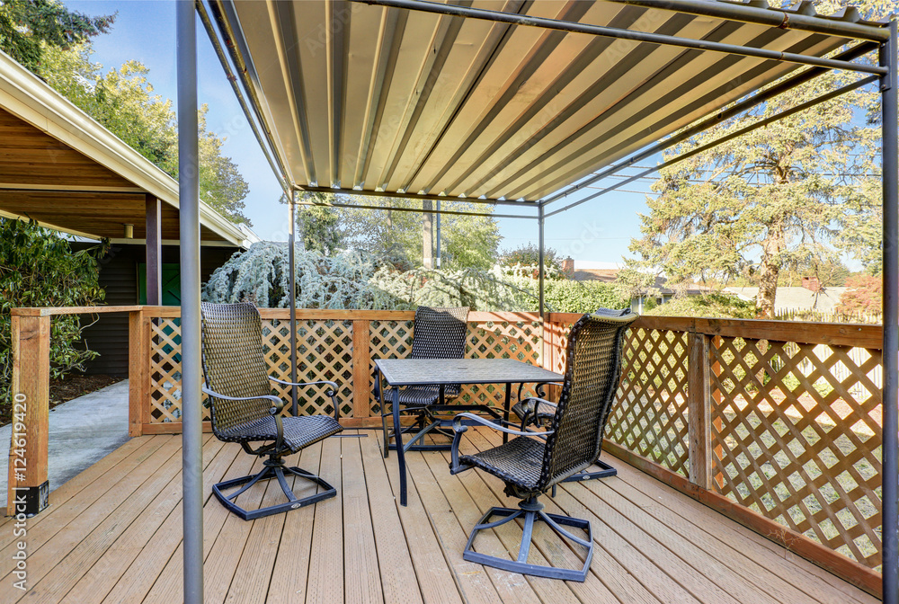 Covered wooden deck with patio table set