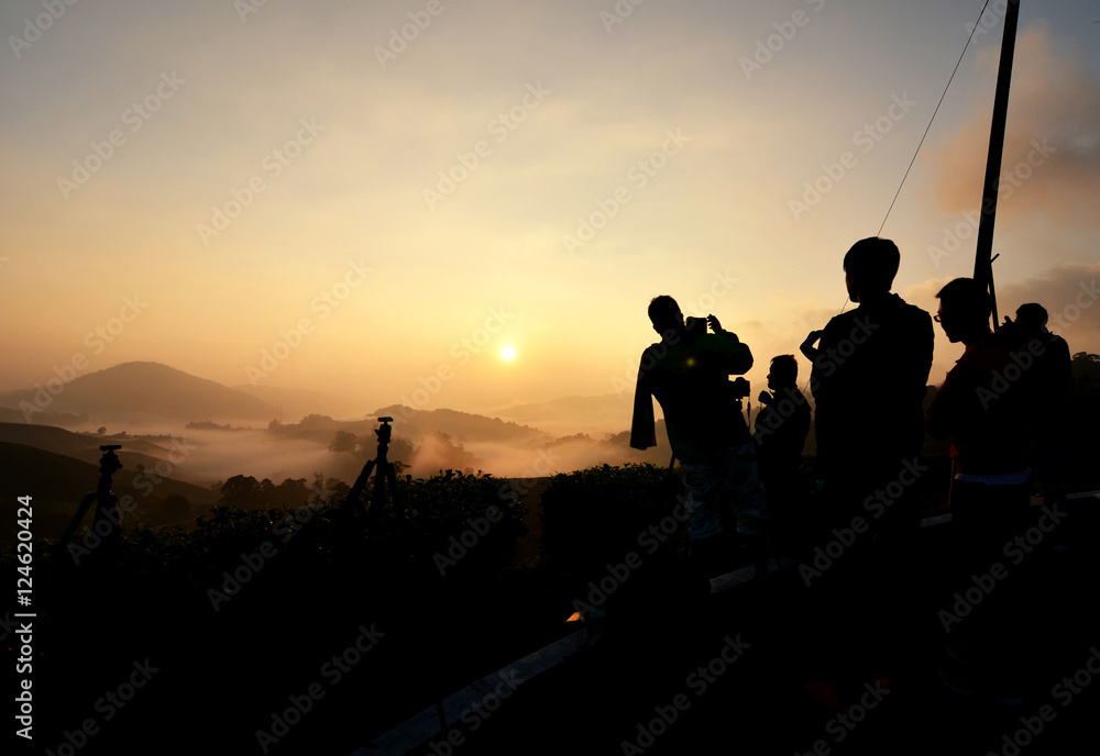 silhouette group of people waiting and enjoy sunrise moment at h