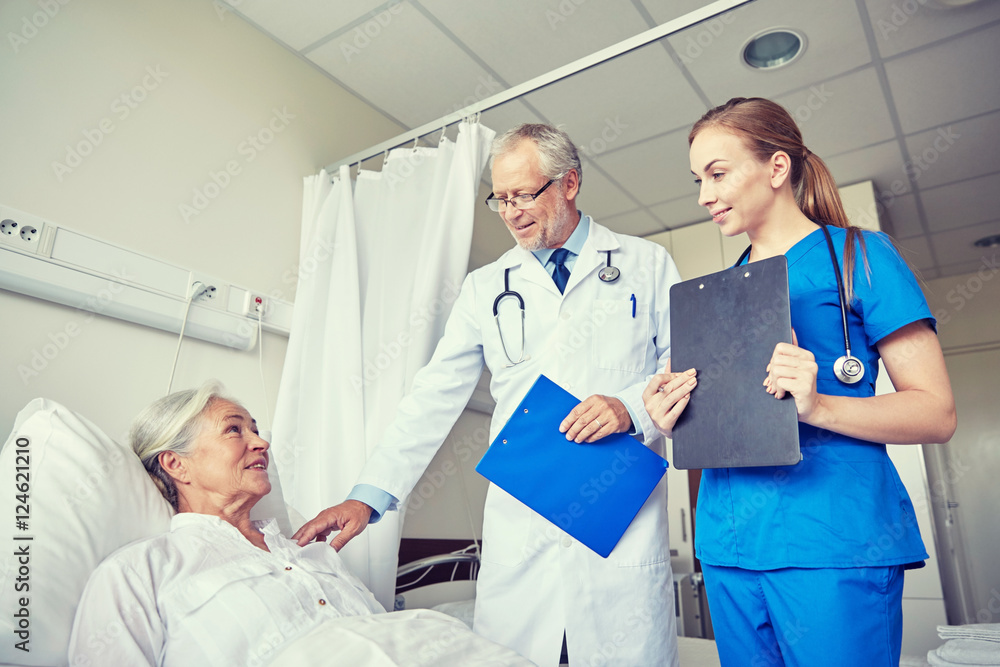Fototapeta premium doctor and nurse visiting senior woman at hospital