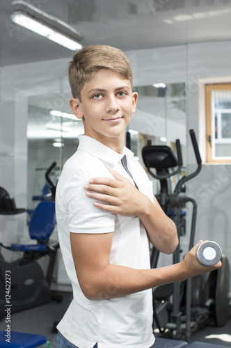Teenage boy engaged in the gym hall