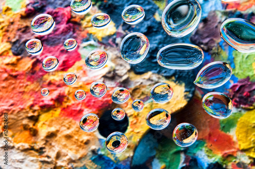 Water drops on colorful painting palettes background