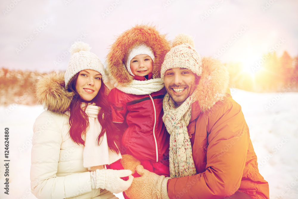 happy family with child in winter clothes outdoors