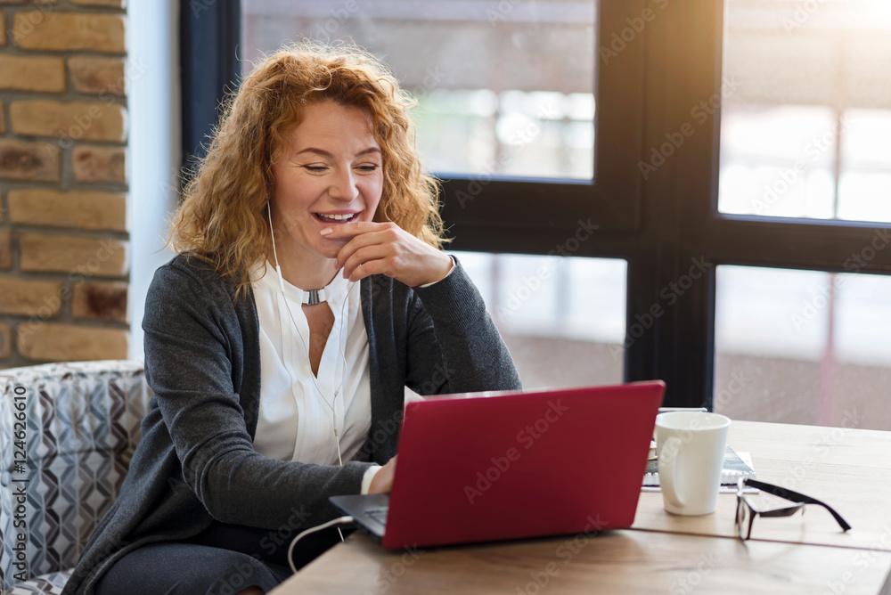 Happy woman using laptop in cafe Happy woman using laptop in cafe