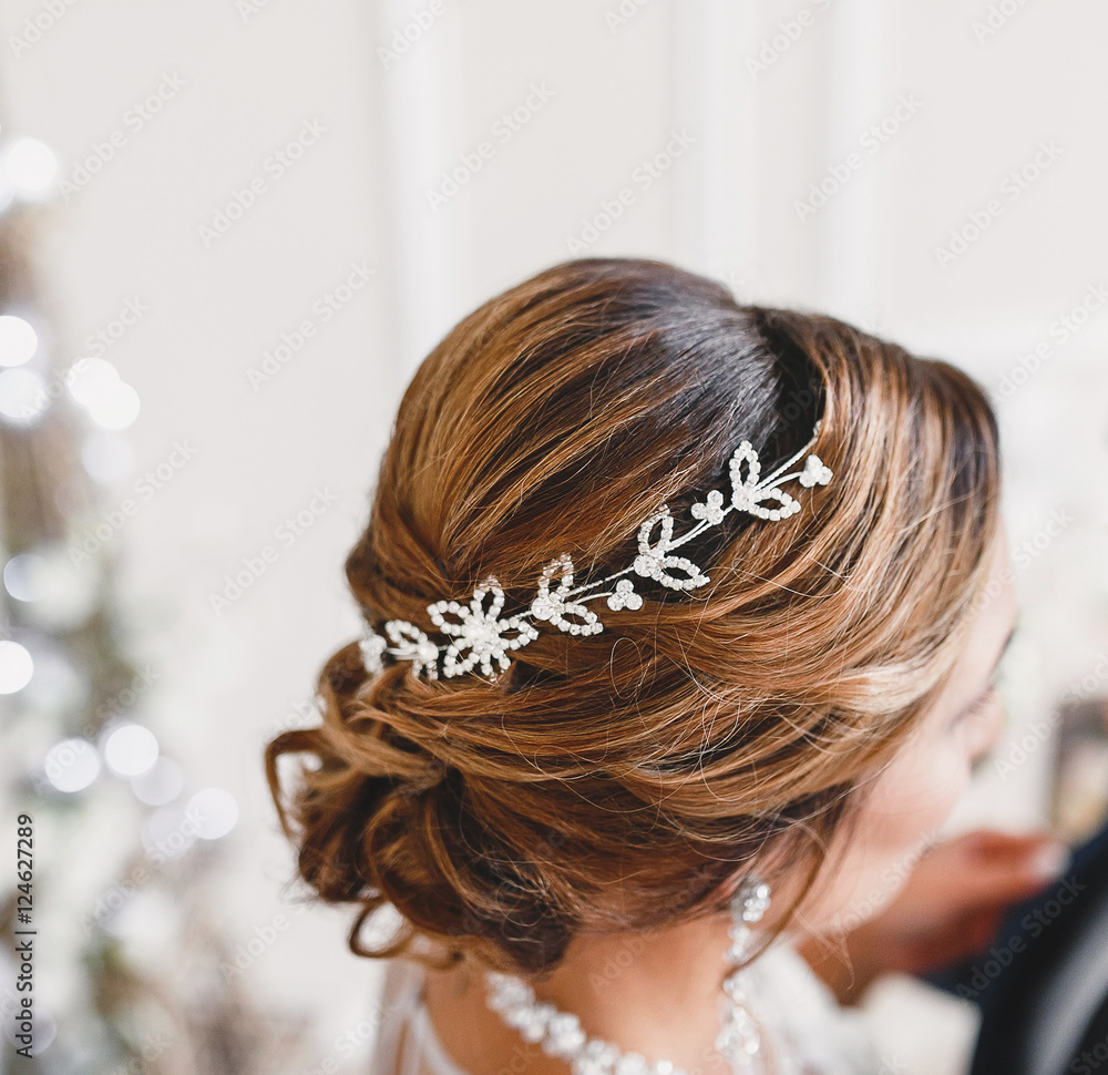 Portrait of attractive young woman with beautiful hairstyle and stylish hair accessory, rear close-up view