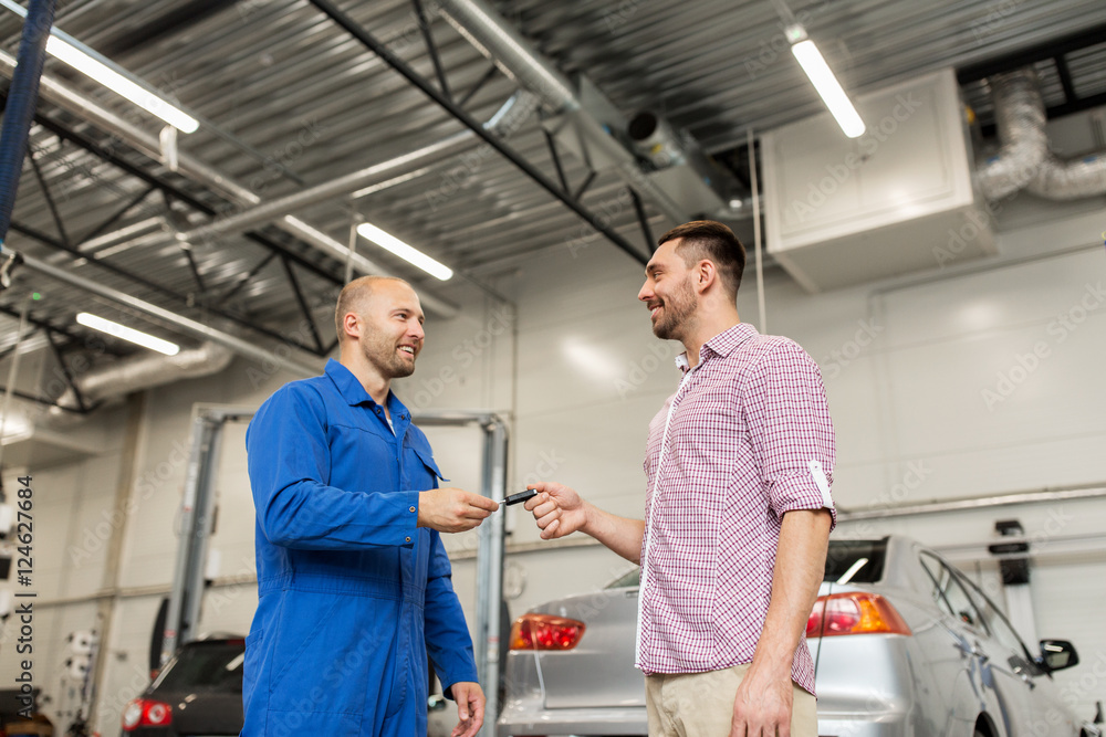auto mechanic giving key to man at car shop auto mechanic giving key to man at car shop