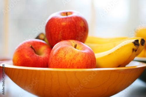 Fototapeta Naklejka Na Ścianę i Meble -  Apples and Bananas in a Wooden Bowl