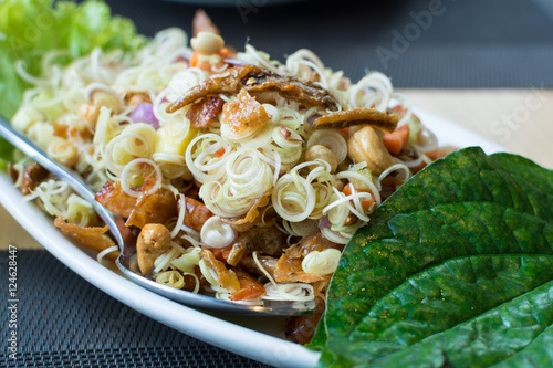 Spicy lemongrass salads with chaplo leaves on the dish photo