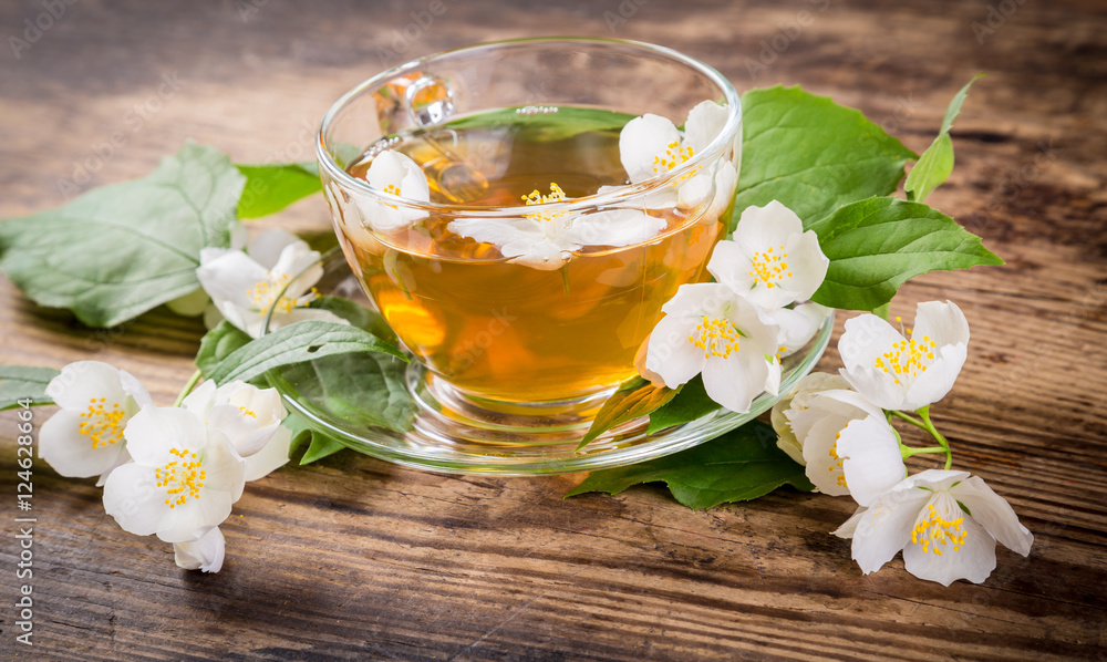 Herbal tea with jasmine flowers on rustic table Herbal tea with jasmine flowers on rustic table