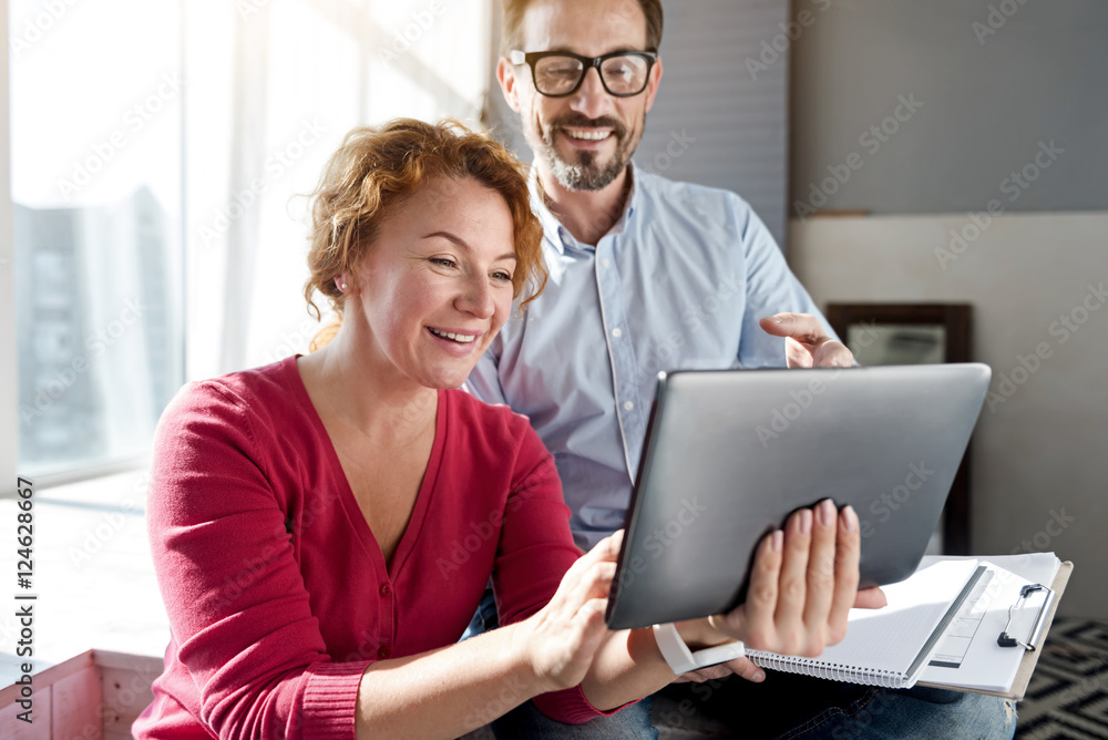 Woman using tablet with her husband Woman using tablet with her husband