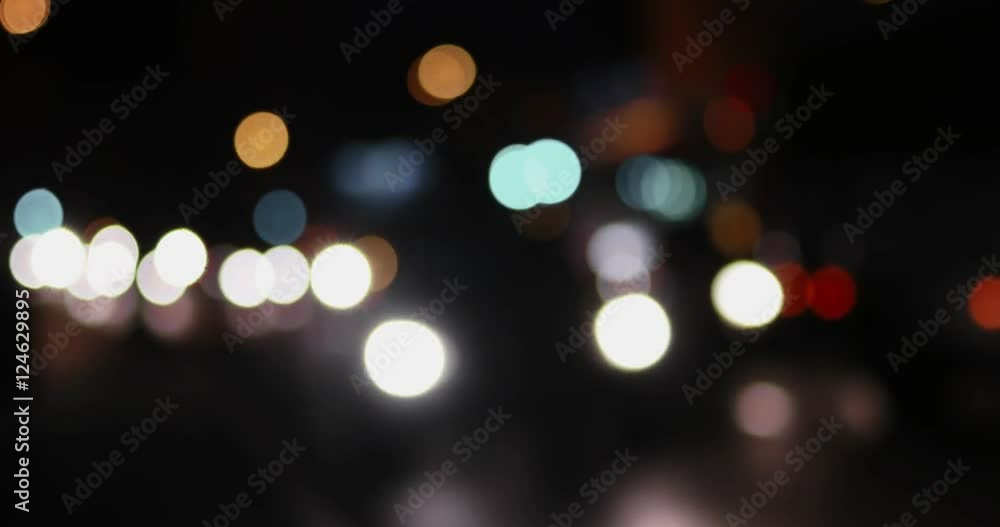 Night city street bokeh. Defocused lights blurred traffic on road. Nightlife abstract blurred shot. Night urban scene out of focus Night city street bokeh. Defocused lights blurred traffic on road. Nightlife abstract blurred shot. Night urban scene out of focus