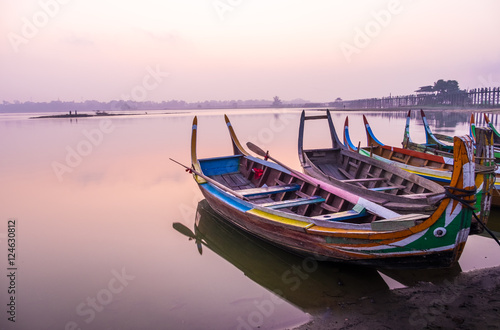 Sunrise scene with boat at lake at Ubeng bridge Mandalay Myanmar