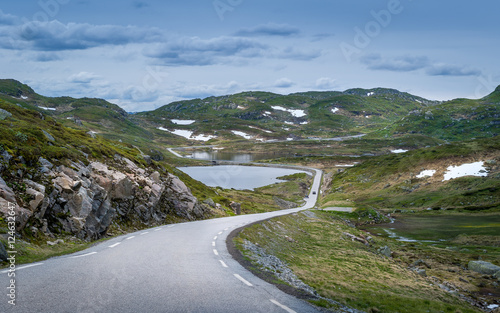 Scenic Norwegian road throgh the lakes and rocks with some snow
