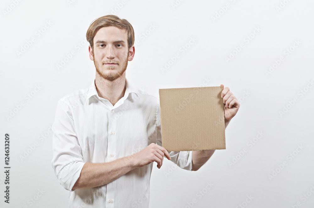 Young Adult Man in White Shirt Holding a Cardboard Inscription Young Adult Man in White Shirt Holding a Cardboard Inscription
