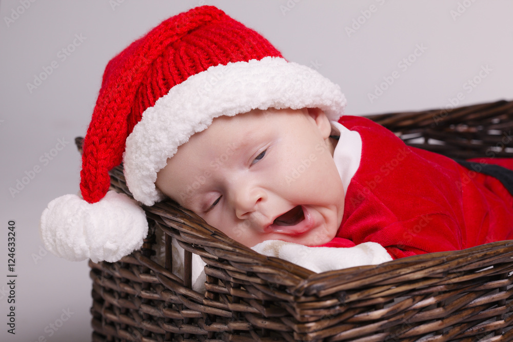 cute baby with santa costume lying in basket cute baby with santa costume lying in basket