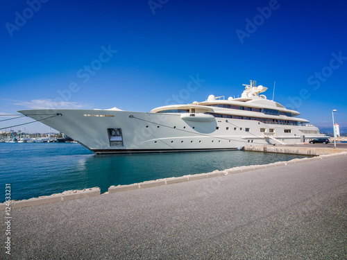 Gigantic big and large luxury mega or super motor yacht at dock photo