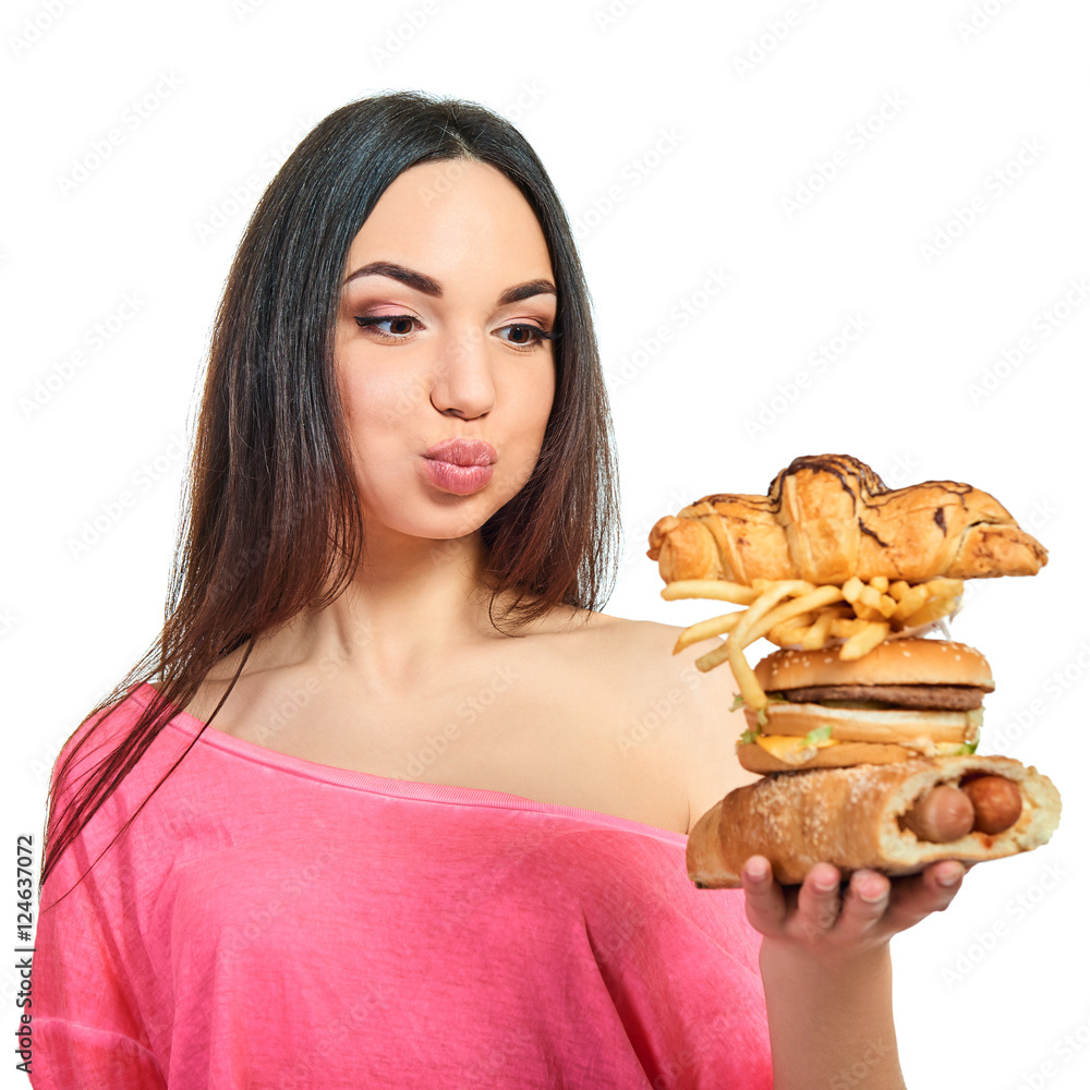 Young woman with fast food. Girl eating hamburger and fries over Young woman with fast food. Girl eating hamburger and fries over