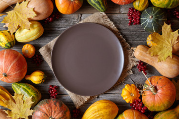 Autumn pumpkin harvest decoration frame empty blank space for design text with plate Thanksgiving dinner or Halloween setting on vintage wooden background wallpapper