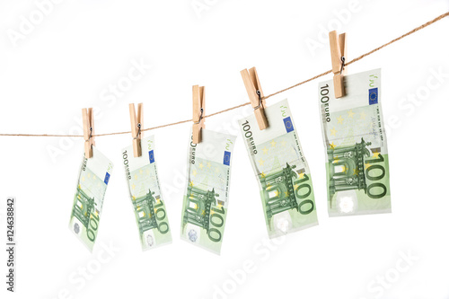 100 Euro banknotes hanging on clothesline on white background.
