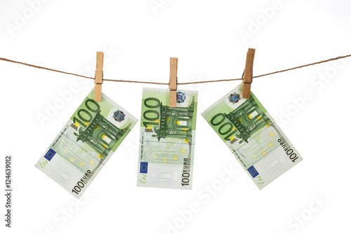 100 Euro banknotes hanging on clothesline on white background.