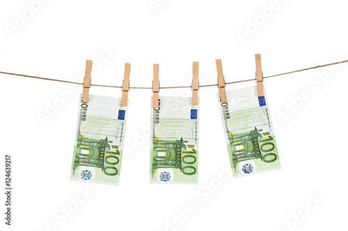 100 Euro banknotes hanging on clothesline on white background.