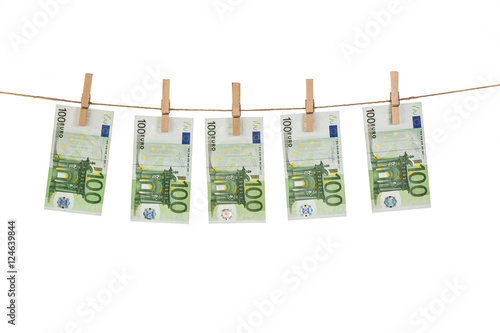 100 Euro banknotes hanging on clothesline on white background.