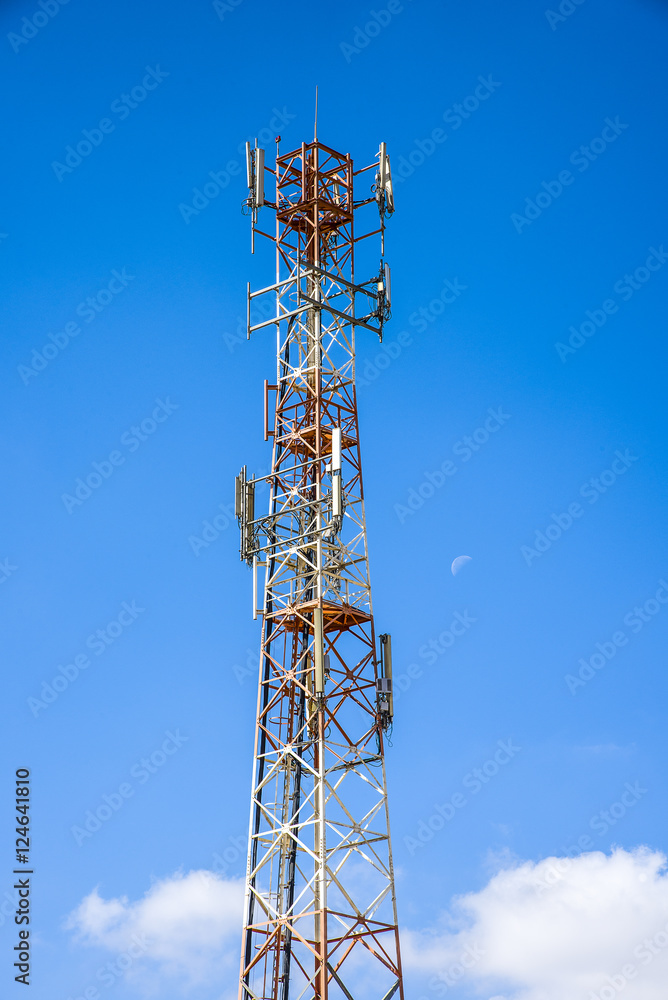 Cellular antenna against blue sky and the moon.