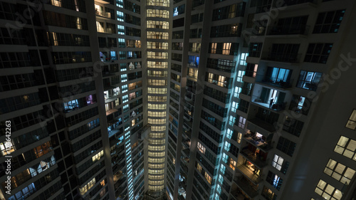Lights in the windows of high-rise apartment block at night. Kuala Lumpur, Malaysia © danr13