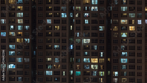 Lights in the windows of multistorey block of flats at night. Kuala Lumpur, Malaysia