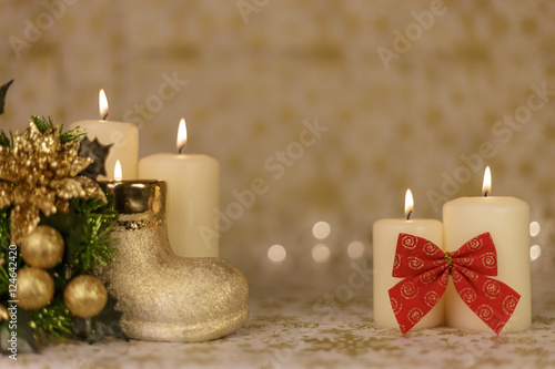 Christmas greeting card with tree, candles, lights, boot and red decoration.