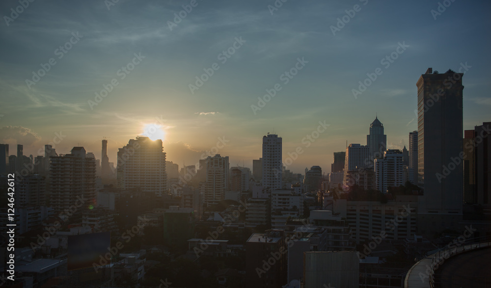 Cityscape with high-rise buildings at sunset. Bangkok in the light of evening sun, Thailand