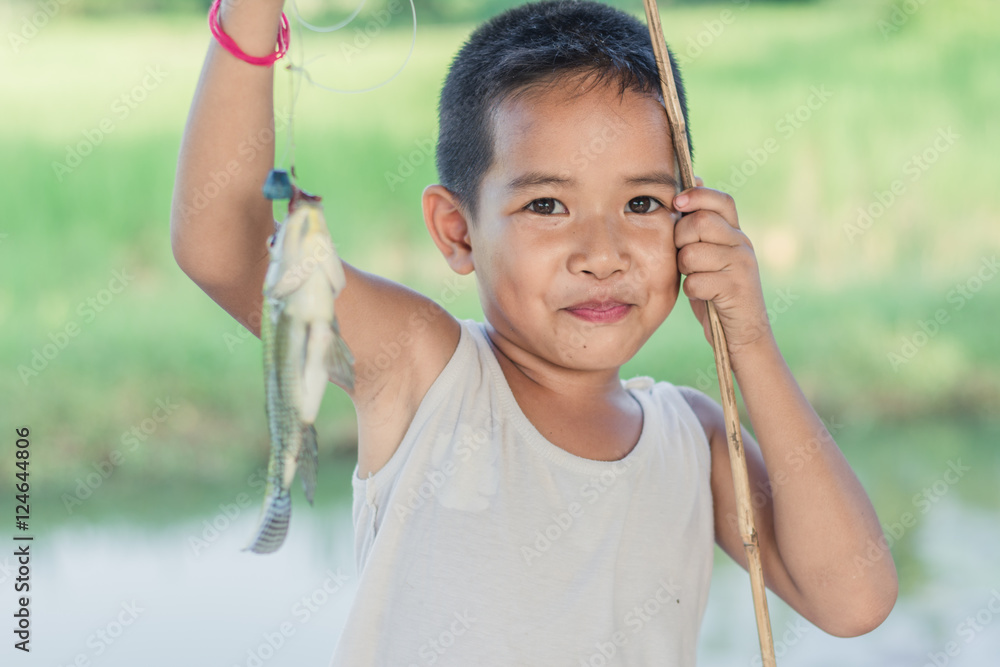 Little Boy Catching a Fish. Kids Fishing. StockFoto Adobe Stock