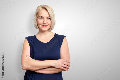 Attractive middle aged woman with folded arms photo