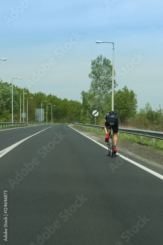 Adult man cycling on countryside road