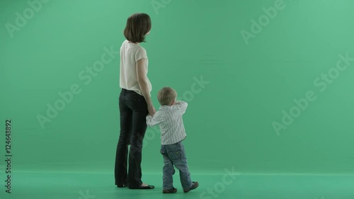 young woman is showing something to the child