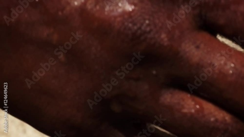 Close up of african people washing hands in water from a tap