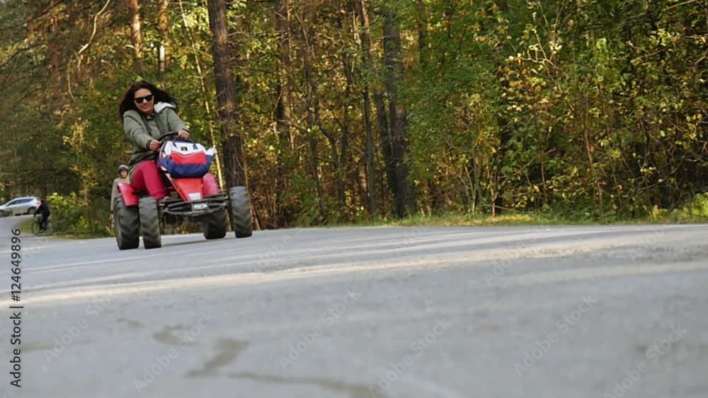 Young beautiful woman in sunglasses driving ATV in slowmotion. 1920x1080 Young beautiful woman in sunglasses driving ATV in slowmotion. 1920x1080