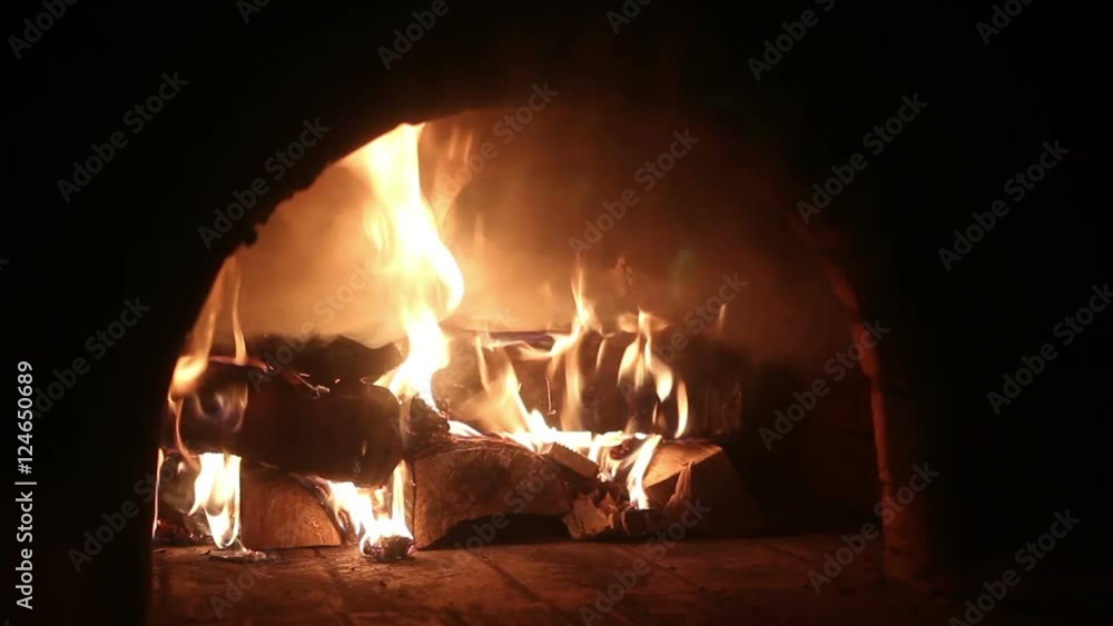Closeup of flame and embers burning in a wood-fired oven. Closeup of flame and embers burning in a wood-fired oven.