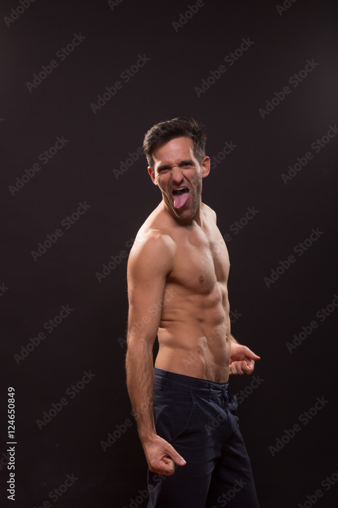 Fototapeta premium young man silly expression tongue posing