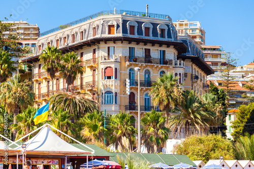 The building in San Remo embankment, Italy. Beautiful historic building on the waterfront in the lush garden. photo