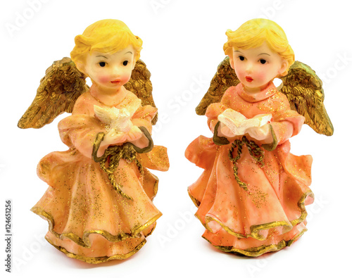 Statuettes of porcelain angels with book and pigeon isolated on white background