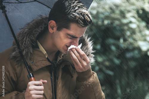 terrified man with handkerchief sneezing, flu