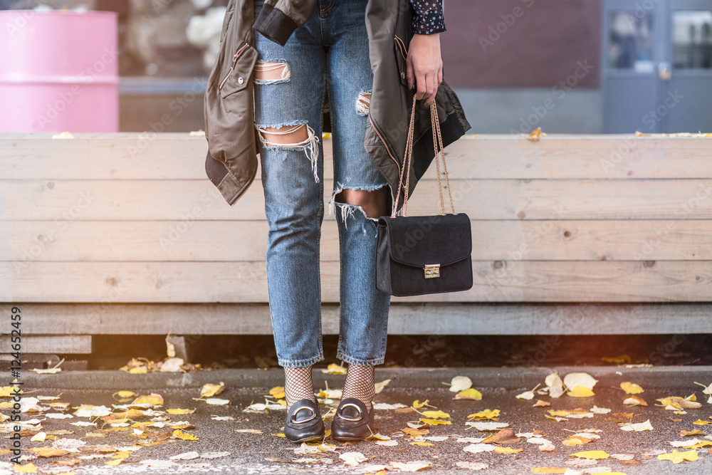 fall fashion outfit details. fashion blogger wearing ripped jeans with  loafers, oversized bomber jacket and a trendy black bag. Stock Photo |  Adobe Stock