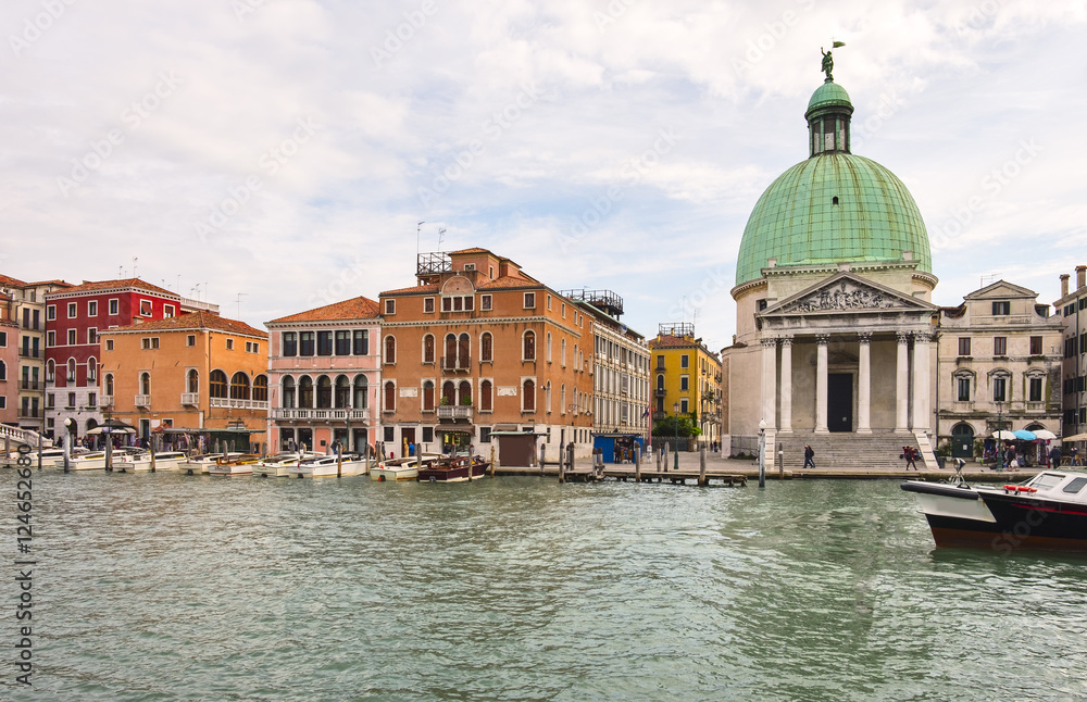 Cityscape view on the Grand canal with dome of San Piccolo Simeone church in Venice